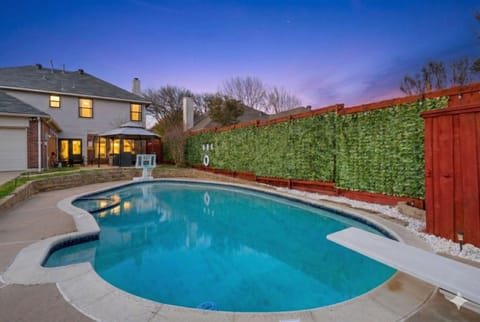 Dive into fun! Your private, sparkling pool and spa await under a beautiful sunset sky, complete with a diving board and basketball hoop.