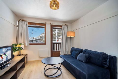 Comfort meets style in this warm lounge with mountain view windows — ideal for couples or small families.
