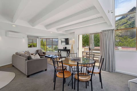 Open plan dining Space with mountain views and sliding doors opening to private balcony 