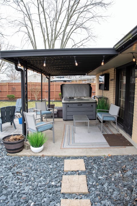 Relax in our private hot tub under a cozy covered patio with twinkling lights.