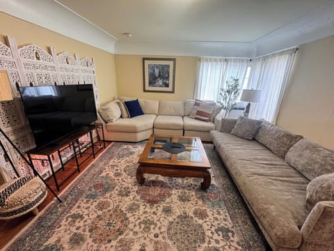 Living room with two large sofas and 55" Samsung smart TV (2025)