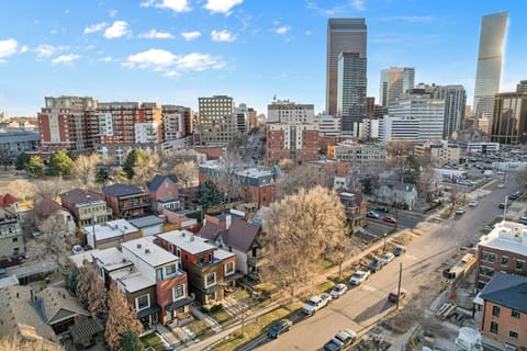 Lively city setting with classic architecture, green streets, and modern skyline views