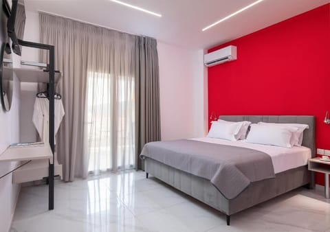 Bright Double Bedroom with Red Accent Wall and Modern Design