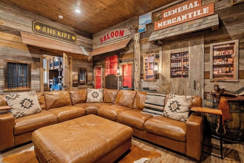 Cozy up and enjoy movie night in this incredible Western-style theater room.