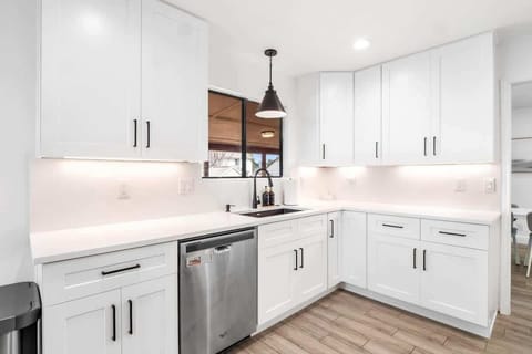 Modern full kitchen with stainless steel appliances, gas stove, dishwasher, and plenty of counter space. Fully stocked with cookware, dishes, and essentials, it’s perfect for preparing family meals or enjoying a morning coffee before exploring Austin