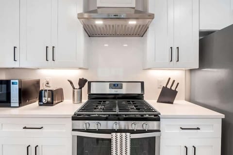 Modern full kitchen with stainless steel appliances, gas stove, dishwasher, and plenty of counter space. Fully stocked with cookware, dishes, and essentials, it’s perfect for preparing family meals or enjoying a morning coffee before exploring Austin