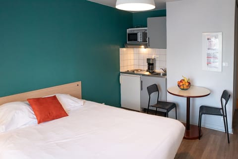 A well-organized studio layout that combines sleeping and dining space in a bright, open setting.