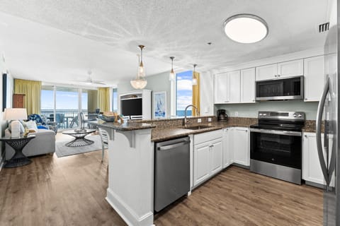 A raised bar with additional seating creates a great spot for casual meals or chatting with the chef.