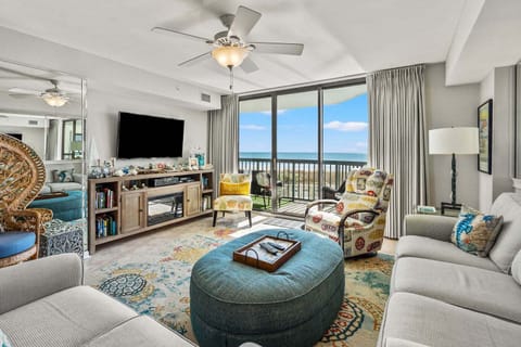 Ocean views through sliding doors in the living room at Ocean Bay Club 107, a 4-bedroom rental from Thomas Beach Vacations