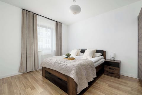 Bright bedroom with double bed and natural light.