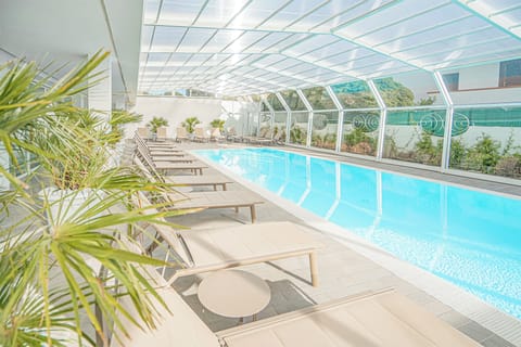 Indoor pool, seasonal outdoor pool, pool umbrellas, sun loungers
