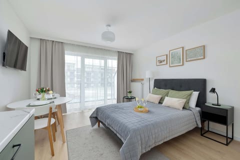 Studio apartment with double bed and seating area.