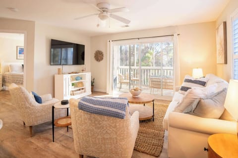 Natural Sunlit Living Space with Comfortable Seating and Smart TV