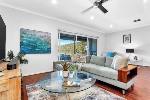 Settle into the light-filled living area, where comfortable seating and calm styling make it easy to slow down after a day out.