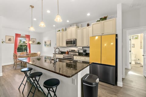 Open kitchen with ample counter space, bar seating, and everything needed for everyday cooking