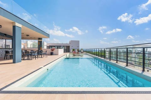 Relax by the rooftop pool; ocean views guaranteed.