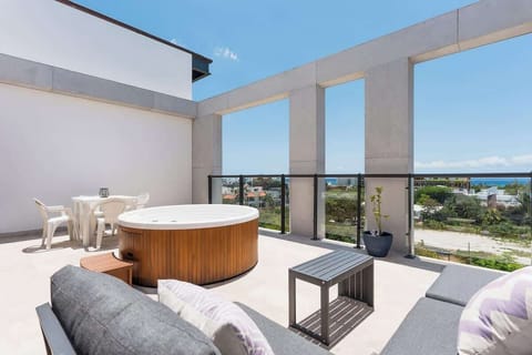 Private rooftop terrace with hot tub and ocean views.