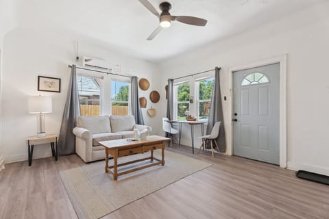 Cozy up in the bright and inviting living room, complete with a soft loveseat, a sunny breakfast nook, and stylish modern decor.