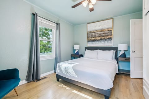 Bedroom 1 — queen bed, ceiling fan, built-in closet