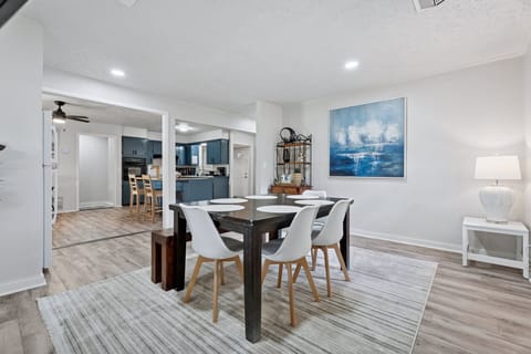 Gather around the dining table for 6, complete with a smart TV and bright wall art—perfect for meals and memories