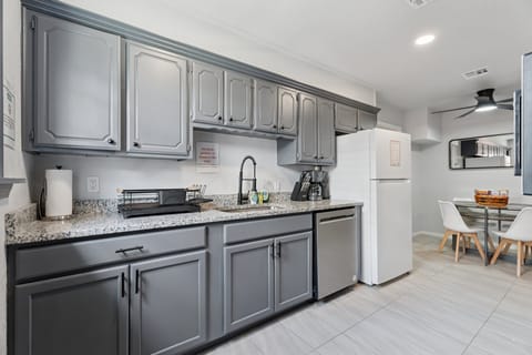 Stocked kitchen includes a full-size fridge, dishwasher, and plenty of counter space for easy meal prep.