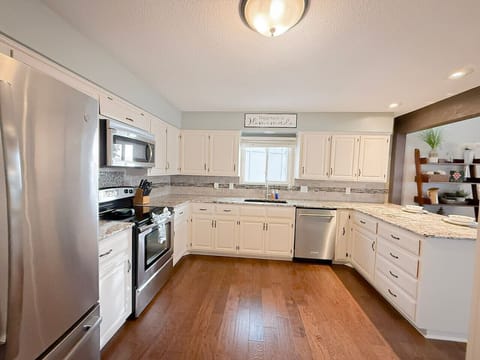 Cook and gather in this spacious, fully equipped kitchen featuring modern appliances, plenty of counter space, and bright, welcoming décor. Perfect for preparing family meals after a fun day on the lake.