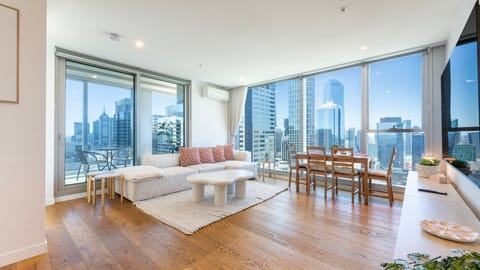 Sun-filled open-plan living and dining with stunning city views
