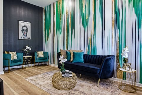 Bold living room with striking abstract art-inspired design Statement wall with black, green, and gold accents
