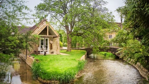 Filly Island is a truly romantic place to relax, set within the tranquil village of South Cerney and accessed via a humpback bridge over the River Churn.