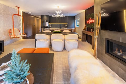 Unwind in your luxurious open-plan living space where modern design meets cozy comfort—complete with crackling fireplace and gourmet kitchen.