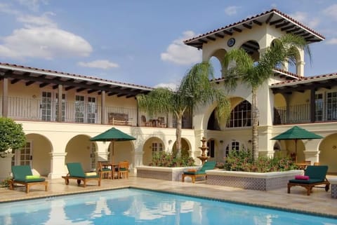 Dive into resort-style bliss framed by elegant Spanish arches.