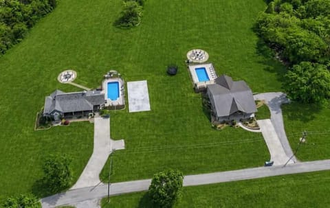 This stunning aerial perspective highlights the charm and versatility of our dual-home retreat. Enjoy the comfort of private living spaces while sharing beautifully maintained outdoor areas ideal for dining, relaxing, and creating lasting memories.