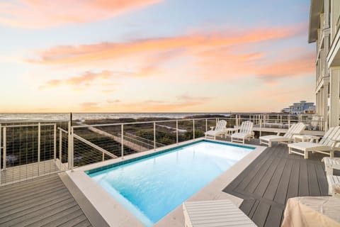 Stunning sunset over the ocean creates a breathtaking backdrop for your private pool deck experience.