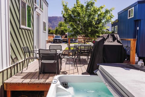 Relax in the outdoor hot tub after a day of exploring Southern Utah, with nearby deck seating and mountain scenery creating an inviting place to unwind.