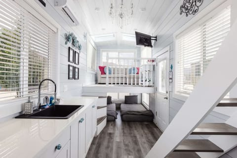 The kitchen is fully equipped with a refrigerator, freezer, microwave, cooktop, and sink with hot/cold water. Enjoy coffee from the coffee maker, with cookware, dishes, utensils, and plenty of storage cabinets to keep everything organized.