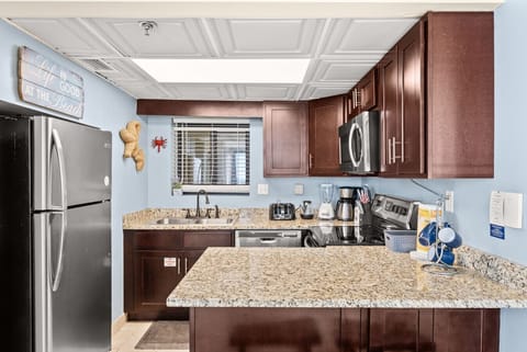 Fully equipped kitchen with granite countertops, stainless appliances, and everything needed to cook at home