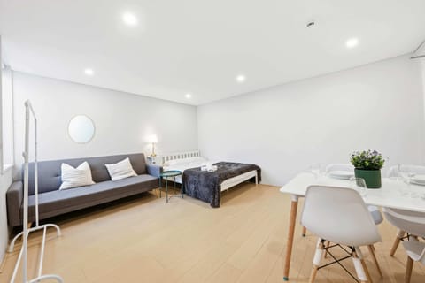 Spacious open-plan studio showcasing the double bed and convertible sofa bed in one cohesive layout.
