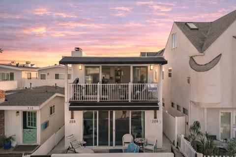 Upper-level unit featuring a private second-floor balcony with outdoor seating and sliding-door access.