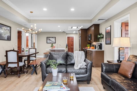 Warm and inviting living room with a stone fireplace, leather seating, and sliding doors leading to a private balcony with mountain views.
