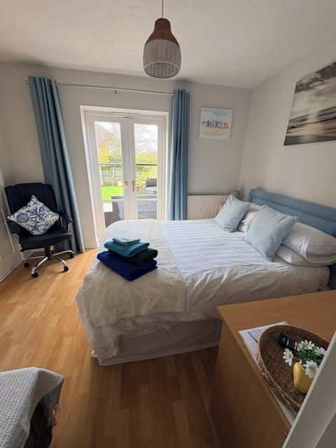 Cozy double bedroom, with patio doors leading to decking.