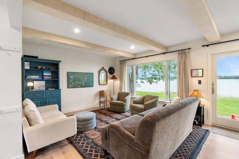 Living area with board games, a smart TV, and views of Crooked Lake.