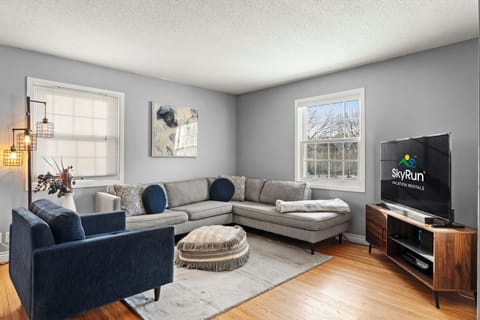 Sink into your spacious sectional sofa and unwind while streaming your favorite shows on the large TV in this stylishly appointed living room.