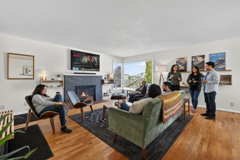 Sunny lounge with fireplace, smart TV, and ample seating for groups