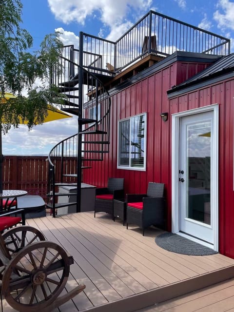 Private outdoor deck and rooftop lounge at Scarlet Horizon featuring spiral staircase access, outdoor seating, and peaceful desert vibes. Perfect for relaxing mornings, sunset views, and stargazing near Zion National Park.
