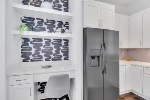 Open-concept kitchen with quartz counters, gas range, and stainless appliances. | Unit A