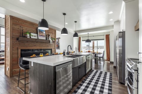 Gather around this inviting kitchen island with dual dishwashers, and seating for six. With the sink facing a cozy fireplace, it's the perfect spot for slow mornings, shared meals, and warm conversation.