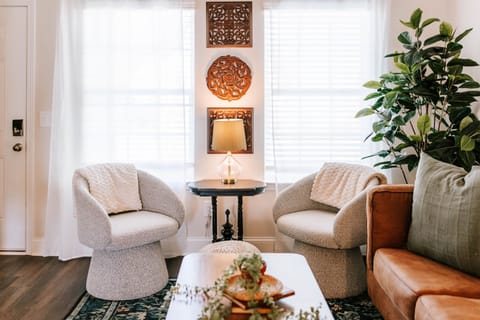 Unwind in style with boucle seating, soft throws, and ambient lighting.