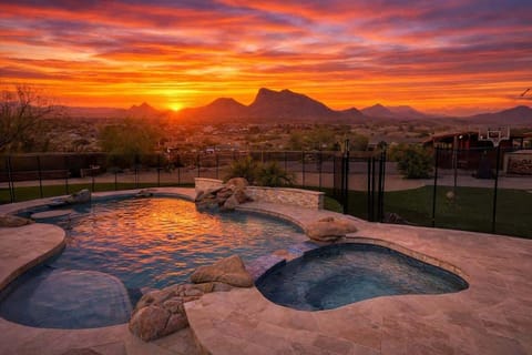 Private backyard with a sparkling pool and hot tub, covered patio with lounge seating and outdoor dining, plus fun amenities including tetherball, volleyball, basketball, a horse stable with swings, mini golf, and darts.