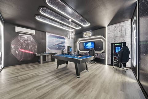Welcome to a gaming paradise where a sleek pool table and bold LED lighting create an exciting atmosphere. The spacious layout is perfect for friendly competition or relaxed gatherings, making everyone feel right at home.