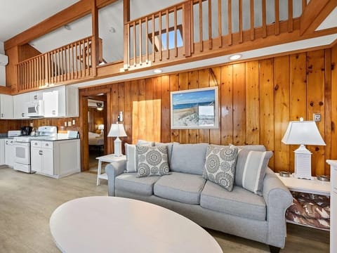 Living room, showing kitchen and loft with skylights (loft for storage only)